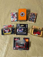 All items laid out showing four Zamboni models, two playing card decks and orange tin