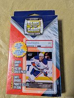 Front of sealed Hockey Gems of the Game box showing sample 2015 Upper Deck Connor McDavid graded card