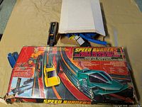 Box front showing Speed Burners graphics and some track pieces