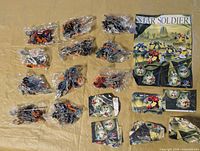 Full lot showing 12 sealed parts bags, poster, and instruction leaflets