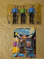 Three loose Star Trek figures with accessories and one sealed Admiral McCoy figure