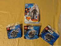 Overview of three LEGO polybags and DC The Engineer figure