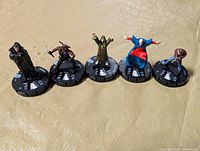 All five HeroClix figures lined on surface
