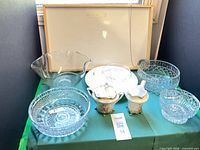 All items grouped on table including glass bowls, porcelain pieces, trays