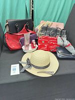 Overall view showing all handbags, hat, lotions, perfume, tray and accessories