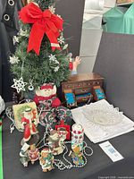Group shot showing tree, figurines, jewelry chest, glass bowl, garland and cloth