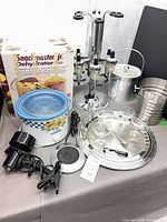 Lot overview: appliances, liquor dispenser stand, ice buckets, crockpot, tray with glasses