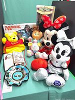 Group shot of all items including plush, board game, plate, stamps, heart pillow