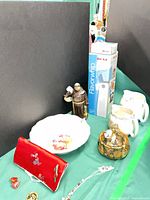 Group shot showing appliance box, figurine, ceramics, clutch and jewelry