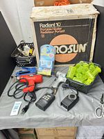 Group shot with heater box, tools, cords, storage containers