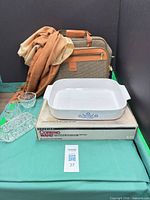 Lot overview showing casserole, tote, scarf and crystal pieces