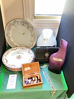 Group shot of plates, platter, vases, clutch, jewelry box, necklace