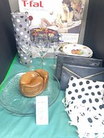 All items group shot showing grill box, glassware, plates, platter, wooden bowl, purses, scarf, gift tube