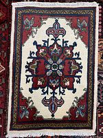 Full view of hand-made Ardabil wool rug showing overall design and fringes