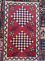Full view of red Shiraz rug showing entire pattern and border