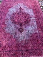 Full view of rug showing central medallion and distressed fading