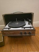 Lid open showing platter, tonearm, controls