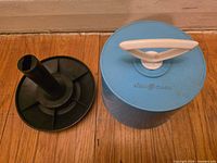 Case opened showing removable spindle and lid interior view