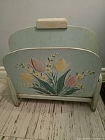 Full view of wooden mint green hand-painted floral magazine rack