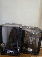 Both boxed electronic banks side by side