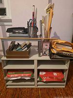 Overall view of paper sorter stacked with mesh shelf, pen cup, stapler, file holder and envelopes