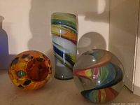Vase, paperweight, and bowl grouped on shelf