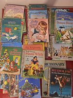Spread of Little Golden Books showing multiple titles including Disney stories and holiday books