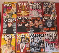 12 MOJO magazines laid out showing variety of covers