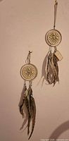 Full view of two dreamcatchers hanging on wall