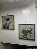 Both ceramic plaques hanging side by side to show size and pair