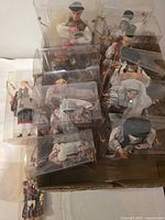 Group view of approximately ten boxed Romanian souvenir dolls plus one loose doll