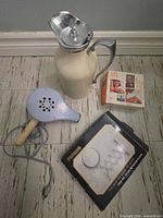 Overall lot showing cream percolator, blue blower, Braun shaver box, Minipac box visible