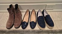 All three pairs lined up: brown suede boots, navy patent loafers, navy suede espadrilles