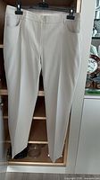 Front view of beige Akris straight-leg pants hanging