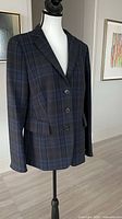 Front view showing plaid pattern, button closure and lapel