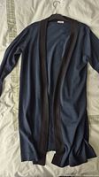 Full view of Akris Punto long cardigan on hanger showing color, length, trim