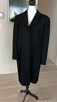 Front view on mannequin showing overall design, notch collar, concealed placket, pockets