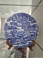 Front view of blue and white charger on stand