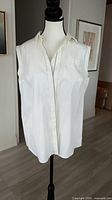 Front view of white sleeveless Brunello Cuccinelli blouse on mannequin