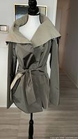Front view of reversible trench coat on mannequin
