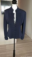 Front view of navy knit Giorgio Armani jacket on mannequin