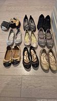 Overview of ten pairs of women’s ballet flats and Mary Janes arranged on floor