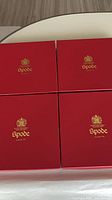 Four red Spode boxes closed