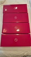 four pink Holt Renfrew boxes stacked