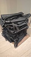 Stack of folded black Holt Renfrew garment bags