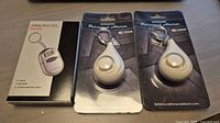 Front view of all three packaged keychain alarms