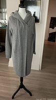 Full front view of gray hooded cardigan on mannequin