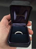 Open Tiffany & Co. box showing platinum diamond eternity ring