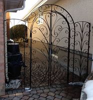 Full view of assembled wrought iron gate between two walls