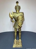 Front view of full brass knight statue